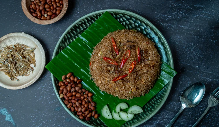 Nasi lemak with rendang on banana leaf